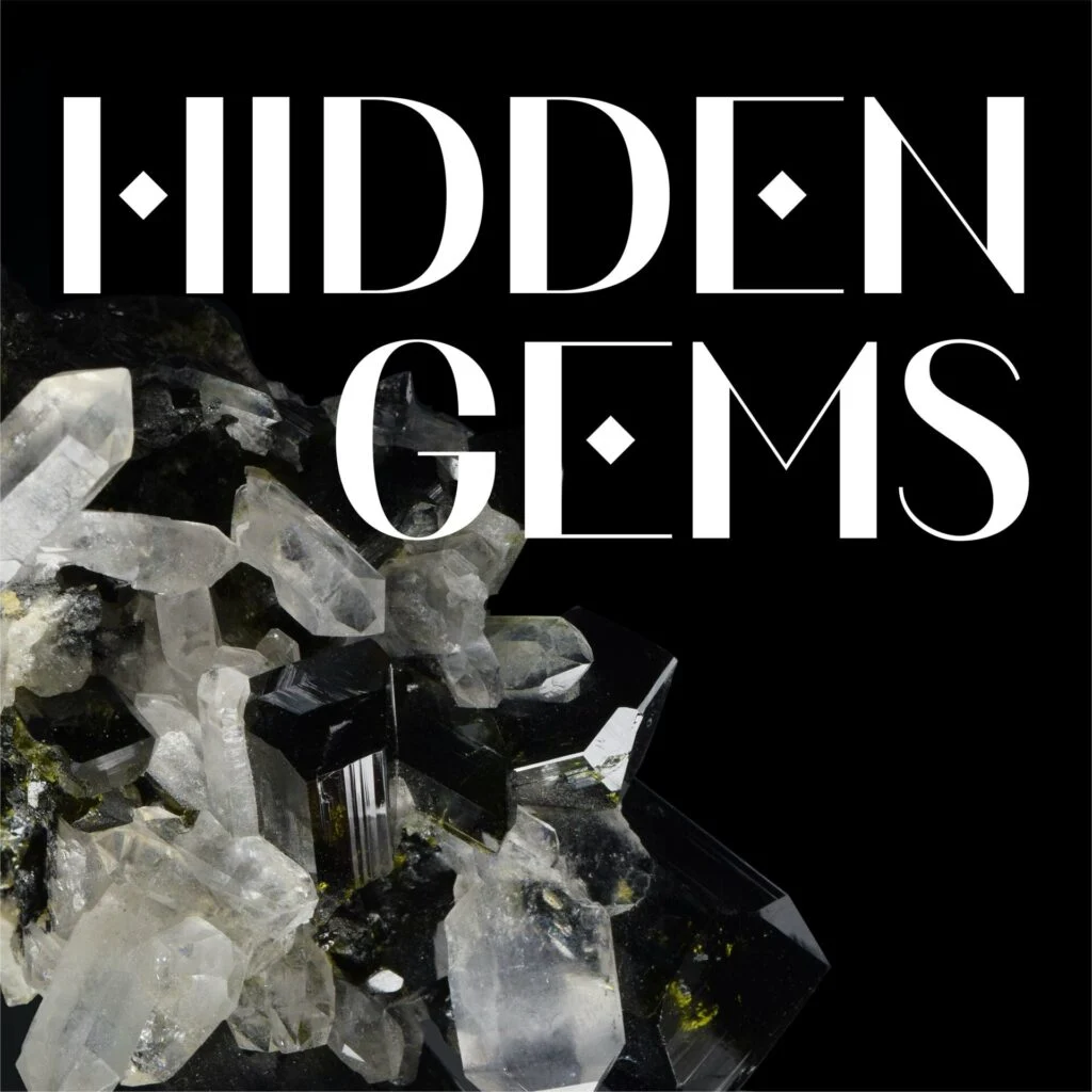 The image features the words "Hidden Gems" in bold white font on a black background, with a cluster of clear and dark crystals at the bottom left.
